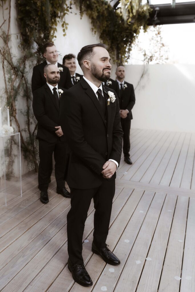 Groom getting emotional as he sees his bride walking down the aisle for the first time.