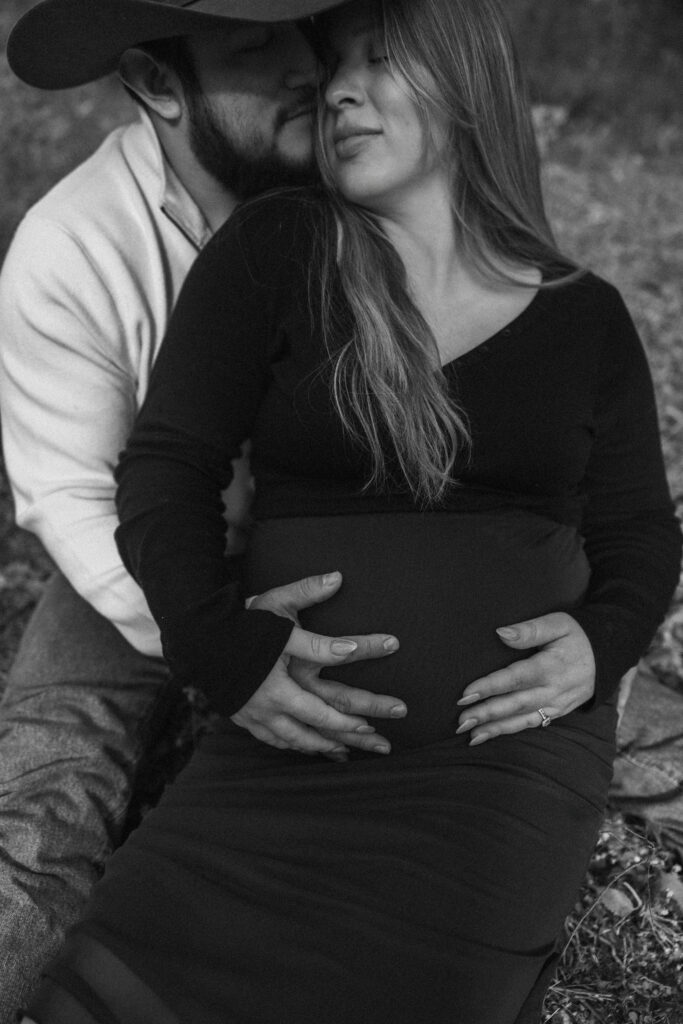 Family celebrating their upcoming baby during a fall maternity session outdoors in Missouri with warm autumn colors and western-inspired styling