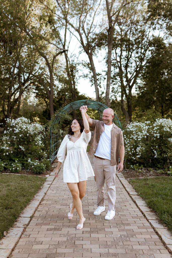 Playful and romantic engagement photos of a couple at Nathanael Greene Park in Springfield, Missouri