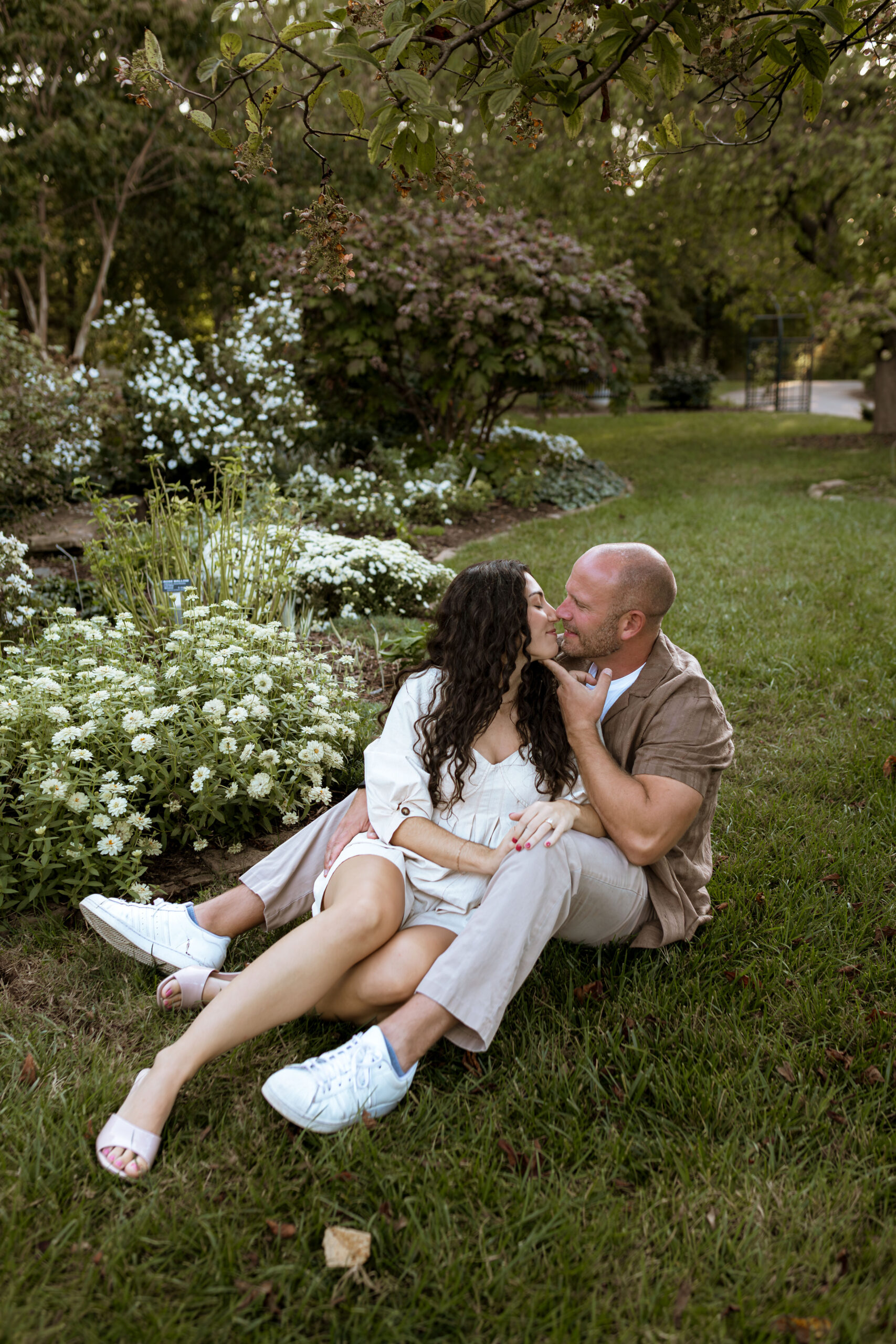 Playful and romantic engagement photos of a couple at Nathanael Greene Park in Springfield, Missouri