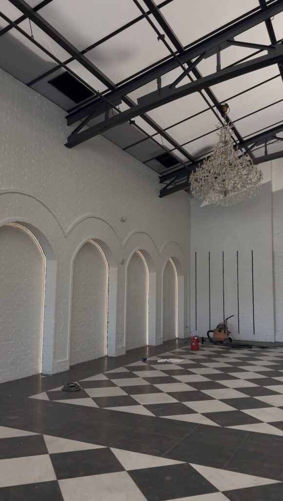 Interior of Arche & Arbour wedding venue in Springfield Missouri featuring crystal chandeliers and European-inspired arches