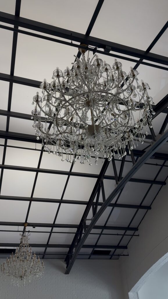 Interior of Arche & Arbour wedding venue in Springfield Missouri featuring crystal chandeliers and European-inspired arches