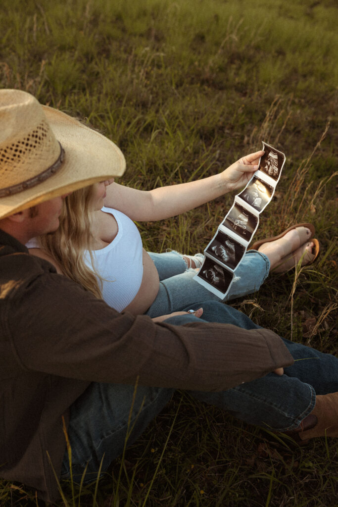 Expecting couple embracing during outdoor maternity session in Missouri with soft golden hour light and earthy documentary photography style.