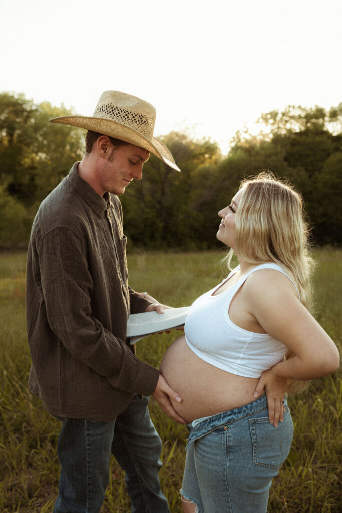 Emotive couple maternity session in Missouri showing connection between expecting parents during golden hour outdoor photography.