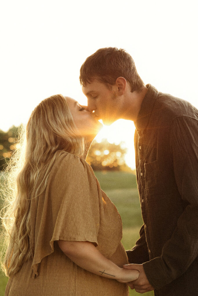 Emotive couple maternity session in Missouri showing connection between expecting parents during golden hour outdoor photography.