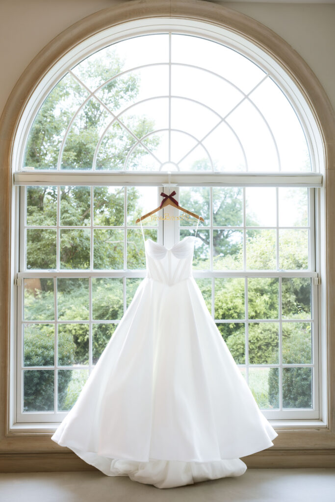 Wedding dress hanging in window detail shot at The Callaway Jewel in Fulton, Missouri